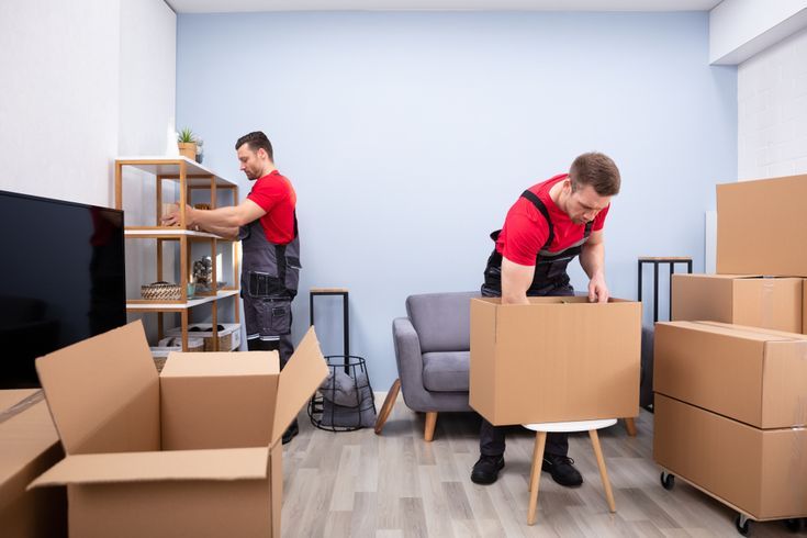 Couple sitting among moving boxes in their new home
